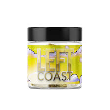 Left Coast infused cannabis flower in a clear glass jar with black lid and colorful yellow label featuring cloud designs.